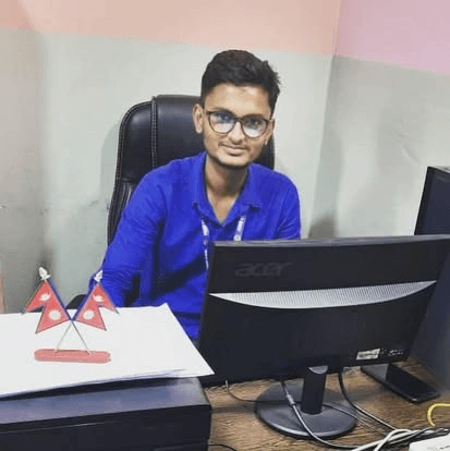 Sunil at Workstation with Nepal Desk Flags
